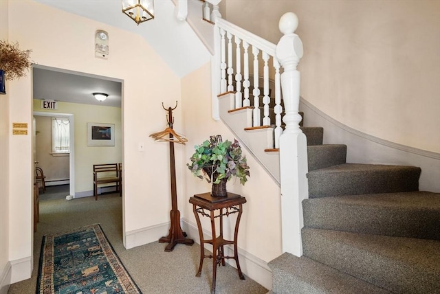 113 Belmont St, Belmont, MA 02478 - staircase with carpet floors, vaulted ceiling, baseboard heating, a baseboard heating unit, and baseboards