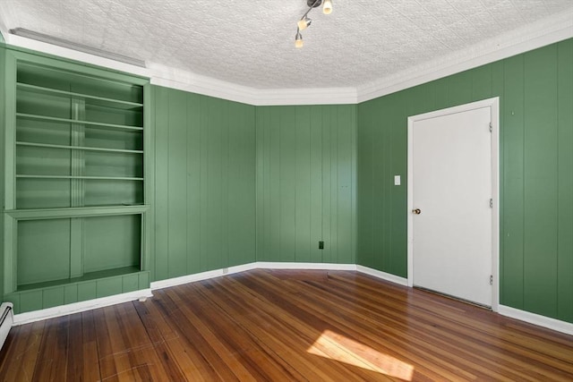 113 Belmont St, Belmont, MA 02478 - empty room with wood finished floors, baseboards, baseboard heating, and ornamental molding