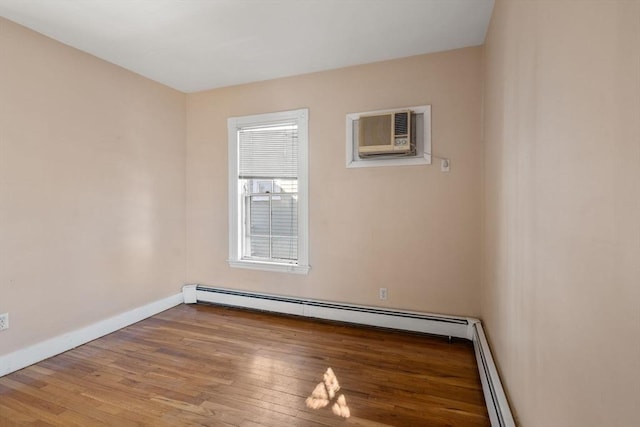 113 Belmont St, Belmont, MA 02478 - unfurnished room with wood finished floors, baseboards, a baseboard heating unit, and an AC wall unit