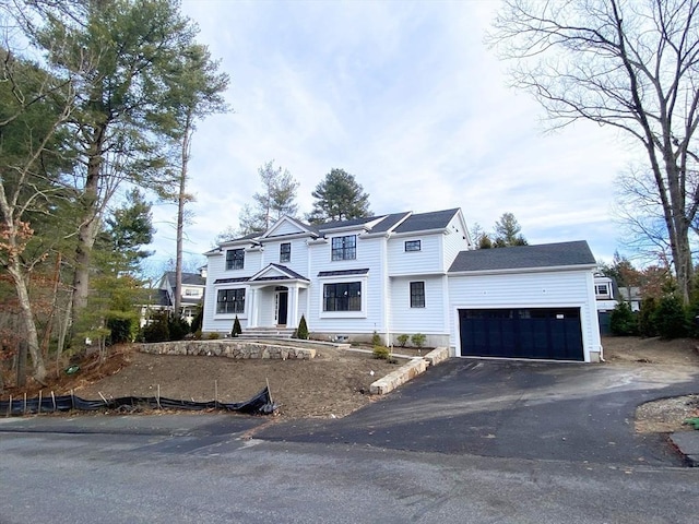 view of front of home with a garage and aphalt driveway