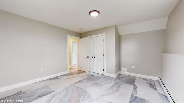 bedroom featuring baseboard heating and a closet