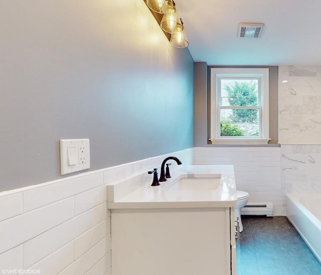 bathroom featuring tile walls, toilet, tile patterned floors, a baseboard radiator, and vanity