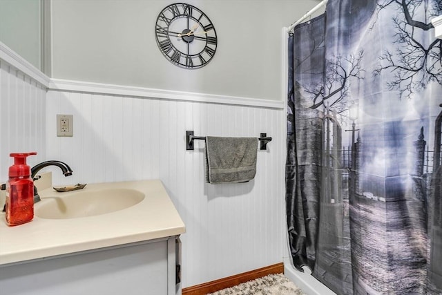 bathroom featuring curtained shower and vanity