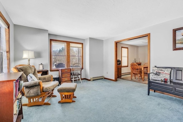 sitting room featuring carpet floors, baseboard heating, a baseboard radiator, and baseboards