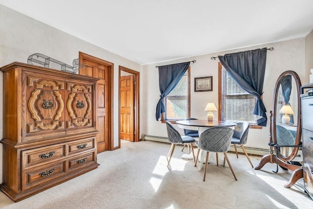 dining space featuring baseboard heating and light colored carpet