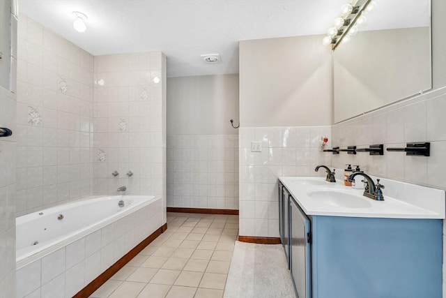 bathroom featuring tile walls, a sink, a bath, and tile patterned floors