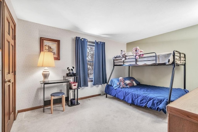 bedroom with carpet floors, wallpapered walls, and baseboards