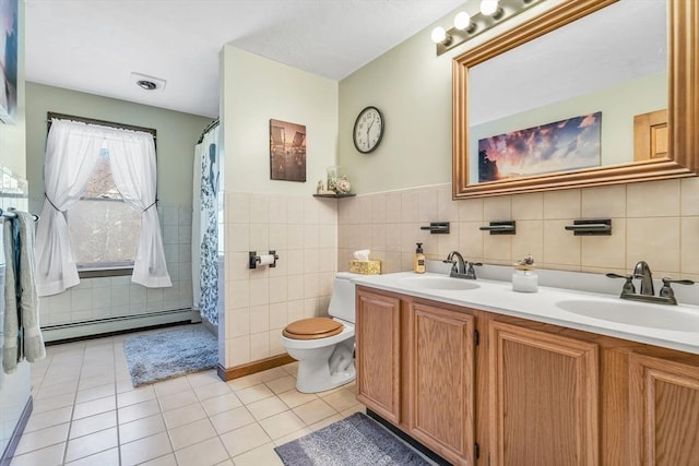 bathroom featuring a baseboard radiator, tile walls, a sink, and tile patterned floors