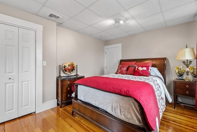 24-26 Lincoln St, North Andover, MA 01845 - bedroom with wood-type flooring, a paneled ceiling, and a closet