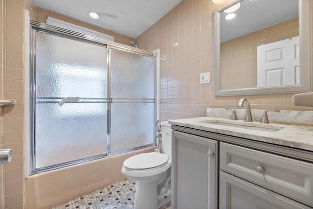 24-26 Lincoln St, North Andover, MA 01845 - bathroom featuring tile walls, vanity, shower / bath combination with glass door, tile patterned floors, and plenty of natural light