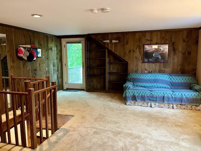 bedroom featuring wooden walls, carpet, and access to exterior
