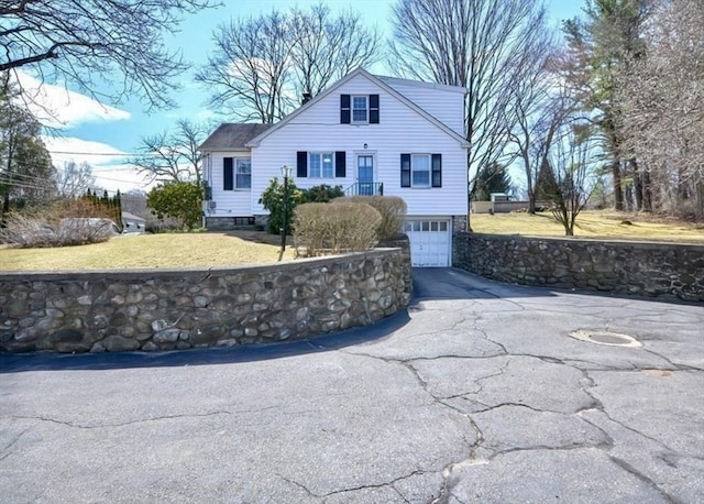 view of front of house with driveway, a garage, and a front lawn