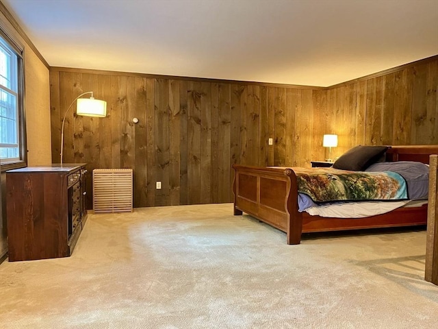 bedroom with carpet flooring and wooden walls