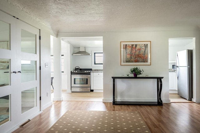 interior space featuring a textured ceiling and light wood-type flooring