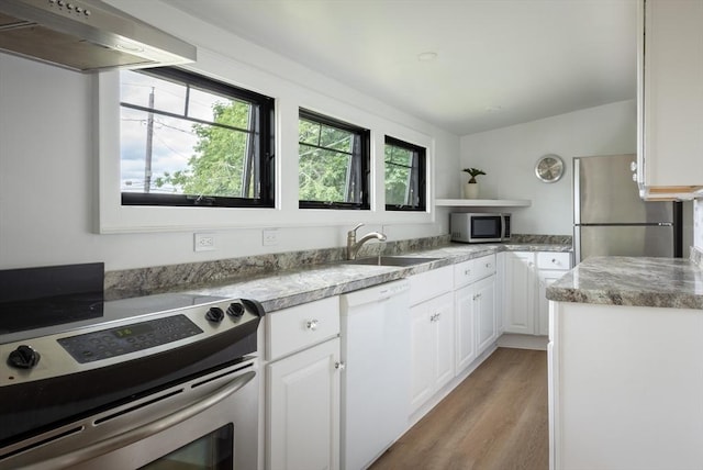 kitchen featuring stainless steel appliances, sink, exhaust hood, light hardwood / wood-style flooring, and white cabinetry