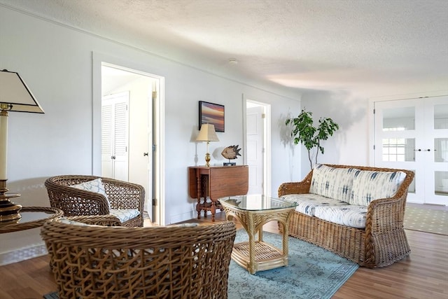 living room with wood-type flooring and a textured ceiling