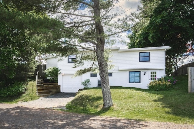 view of front facade with a garage and a front lawn