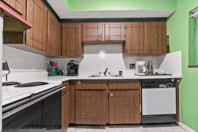 kitchen with brown cabinets, white dishwasher, light countertops, a sink, and range with electric stovetop