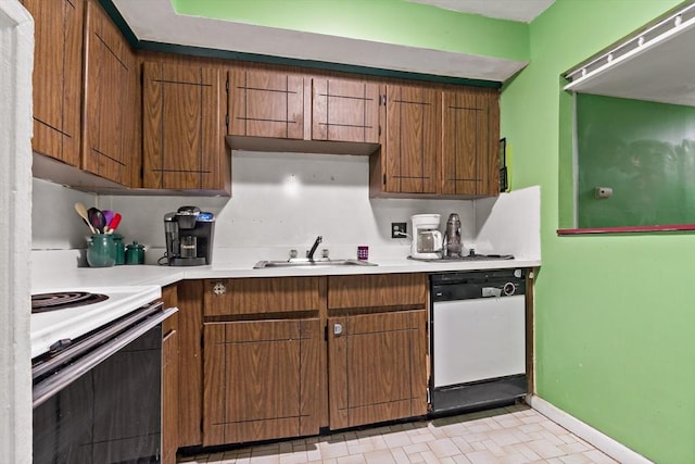 kitchen with range with electric stovetop, light countertops, white dishwasher, a sink, and baseboards