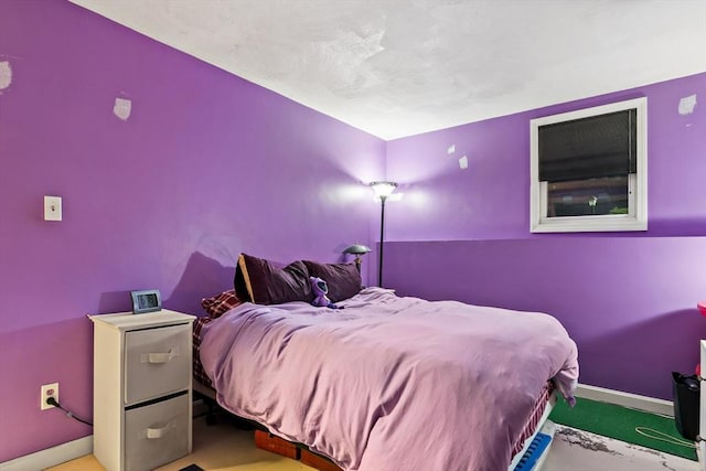 bedroom with carpet floors and baseboards