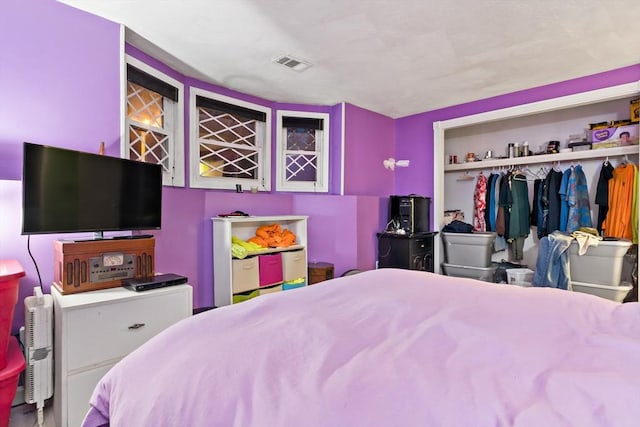 bedroom featuring visible vents and a closet