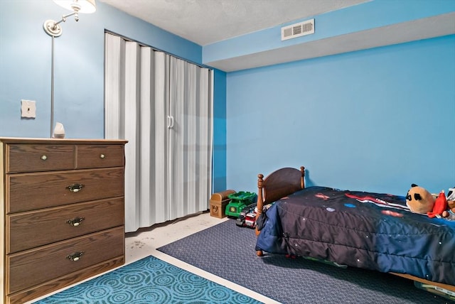 bedroom featuring concrete floors and visible vents