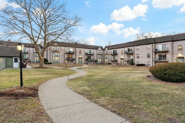 view of community featuring a residential view and a lawn