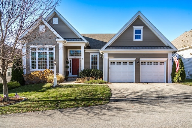 view of front of property with a garage and a front yard