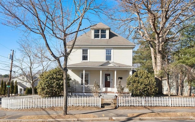 traditional style home featuring a fenced front yard and covered porch