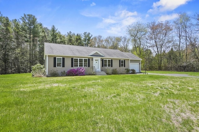 ranch-style home featuring a front lawn and a garage