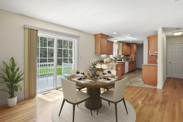 dining area with baseboards, recessed lighting, and light wood-type flooring