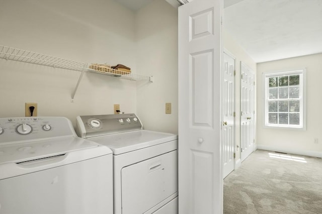 laundry area featuring light colored carpet, independent washer and dryer, and laundry area