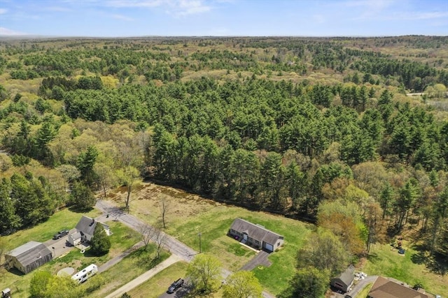 birds eye view of property featuring a forest view
