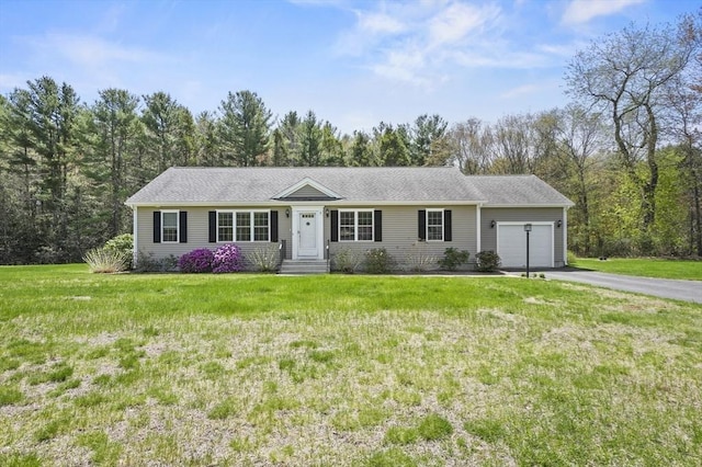 ranch-style home featuring aphalt driveway, a garage, and a front lawn