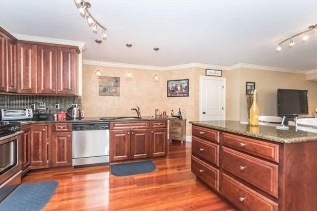 255 Winter St Unit 305, Waltham, MA 02451 - kitchen with appliances with stainless steel finishes, track lighting, wood finished floors, crown molding, and dark stone countertops