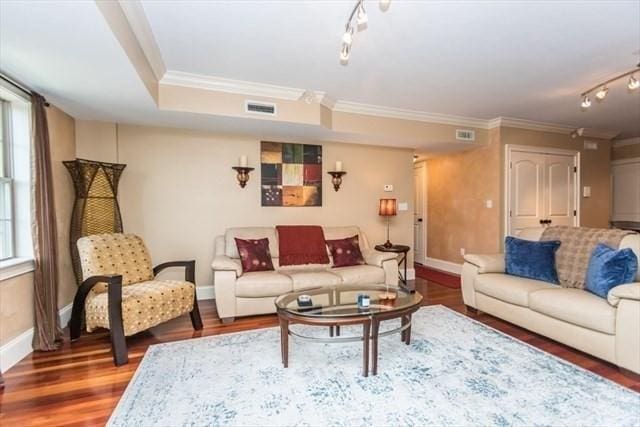 255 Winter St Unit 305, Waltham, MA 02451 - living area featuring rail lighting, plenty of natural light, crown molding, and wood finished floors