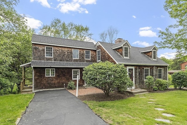 153 Tahattawan Rd, Littleton, MA 01460 - shingle-style home featuring a chimney, a front yard, and a shingled roof