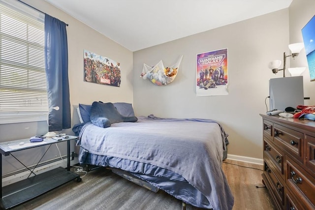 1249-1251 Rockdale Ave, New Bedford, MA 02740 - bedroom featuring wood finished floors, baseboards, and a baseboard radiator