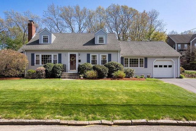 cape cod-style house with roof with shingles, an attached garage, a front yard, a chimney, and driveway