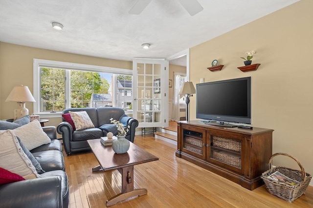 living area featuring a ceiling fan and light wood-style floors