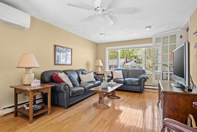 living area with ceiling fan, a wall mounted AC, a baseboard heating unit, and light wood-style flooring