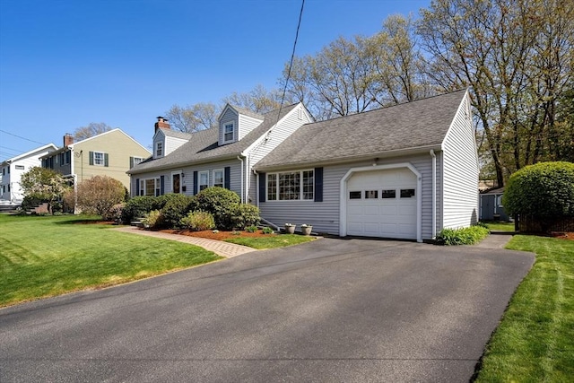 cape cod home with an attached garage, a front lawn, roof with shingles, and driveway