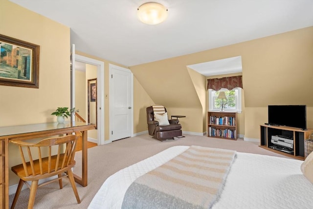 bedroom featuring light colored carpet, baseboards, and vaulted ceiling