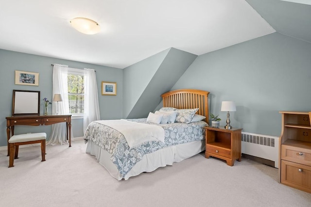 bedroom featuring baseboards, light carpet, and radiator heating unit
