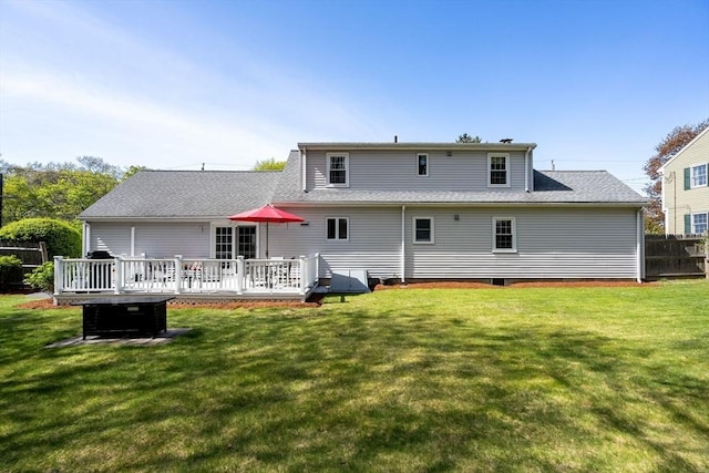 back of house featuring a yard, fence, a wooden deck, and a shingled roof