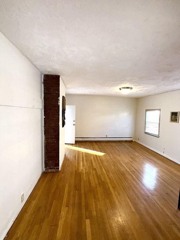 interior space featuring wood-type flooring and a textured ceiling