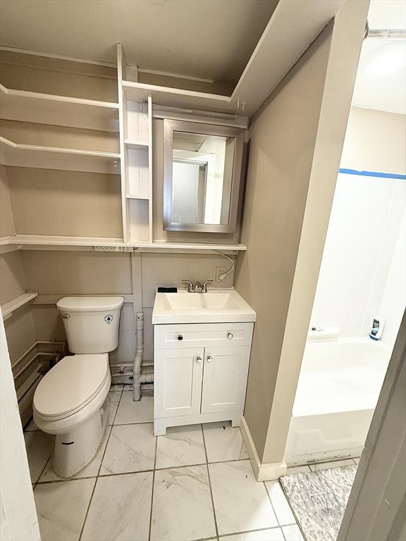 bathroom featuring vanity and toilet