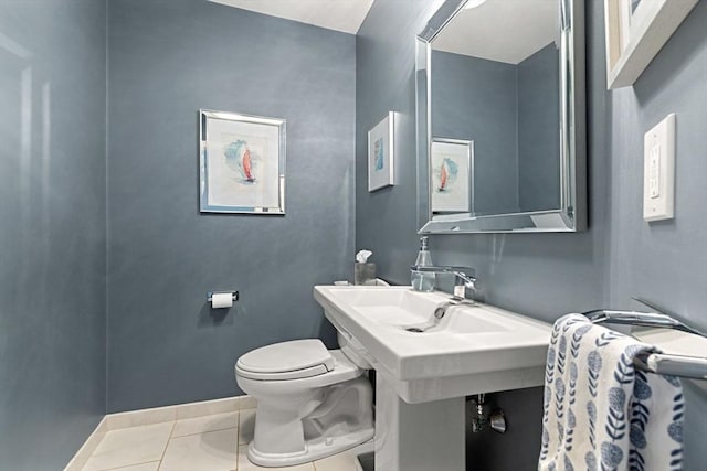 half bath with toilet and tile patterned flooring