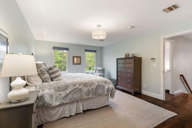 bedroom with wood finished floors and baseboards