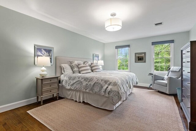 bedroom with baseboards and wood finished floors